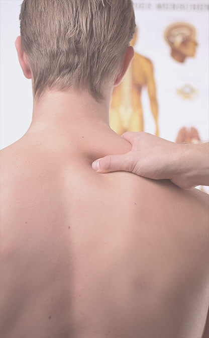 Acupressure on shoulder with man photographed from behind