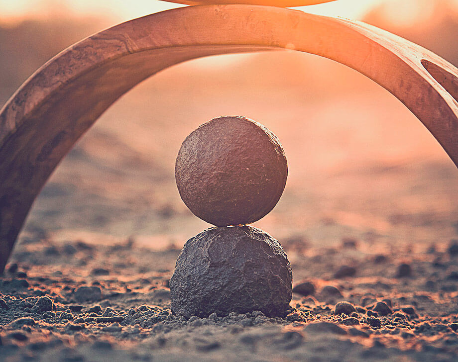 Two round stones under arch of wood