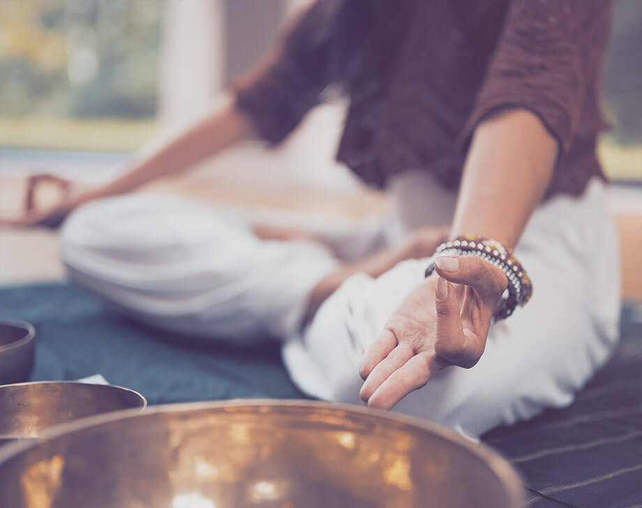 Woman in meditation pose on the floor